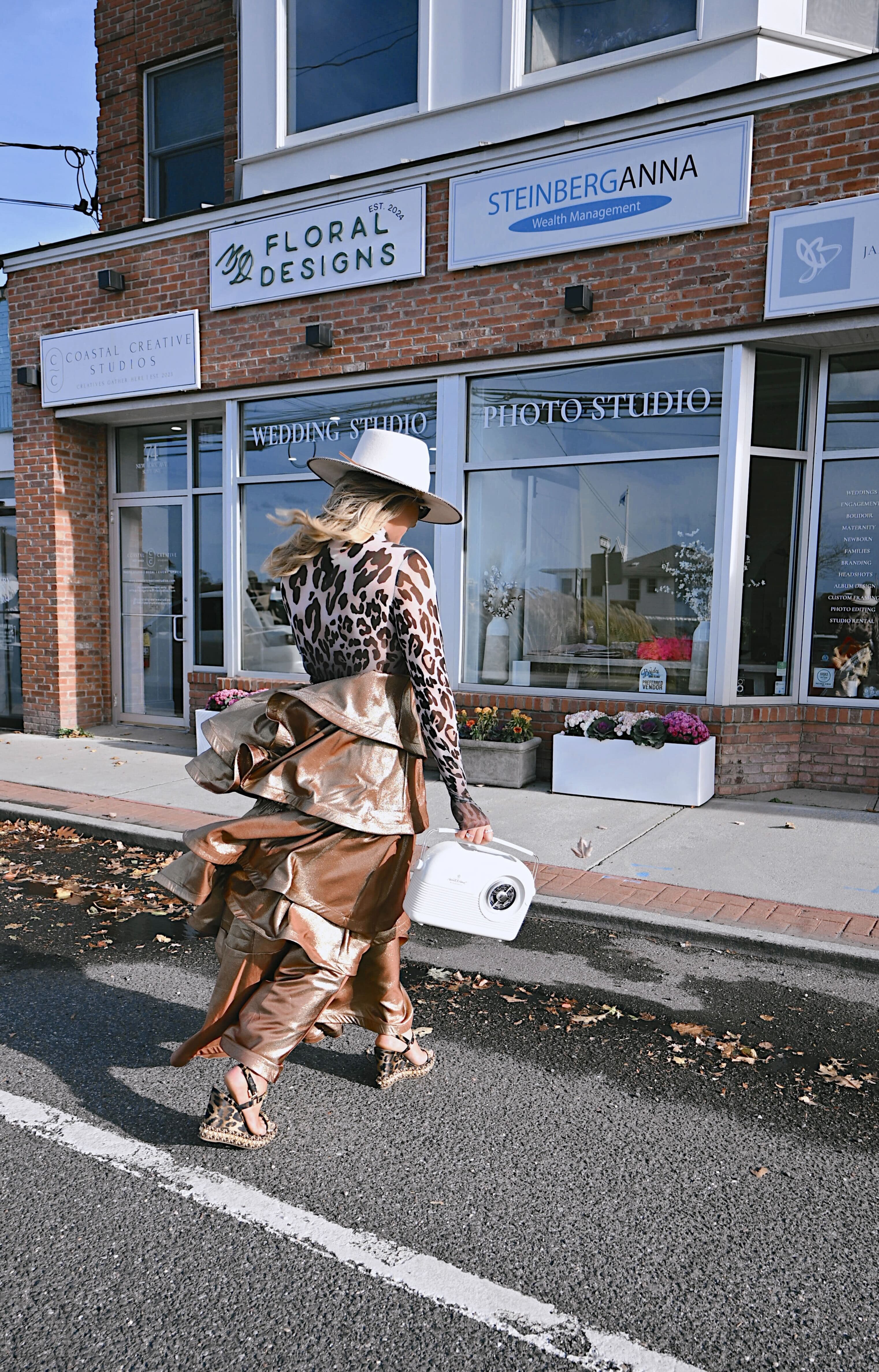 Ashleigh walking past local storefronts